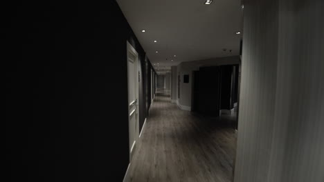Hotel-guest-walking-along-the-empty-hallway