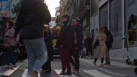 Madrid-street-with-ambulance-driving-and-pedestrians-walking-Spain