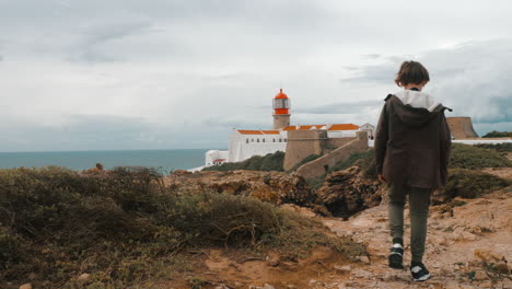Boy-tourist-in-Portugal-taking-photos-of-Cape-St-Vincent-Lighthouse