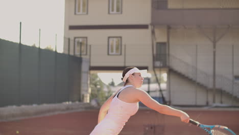 Beautiful-athletic-woman-tennis-player-throws-the-ball-and-strikes-in-slow-motion.