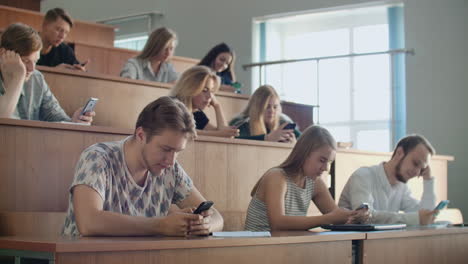 Multi-Ethnic-Group-of-Students-Using-Smartphones-During-the-Lecture.-Young-People-Using-Social-Media-while-Studying-in-the-University