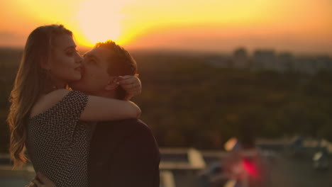 The-lovers-see-eye-to-eye-to-each-other-on-the-roof-at-sunset.-Romantic-couple-on-the-roof.