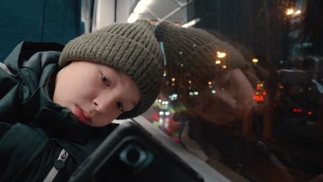 Boy-commuter-using-smartphone-in-the-bus