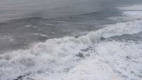 Seascape-with-big-ocean-waves-crushing-against-the-coast-with-big-splash
