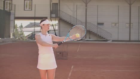 Beautiful-athletic-woman-tennis-player-throws-the-ball-and-strikes-in-slow-motion.