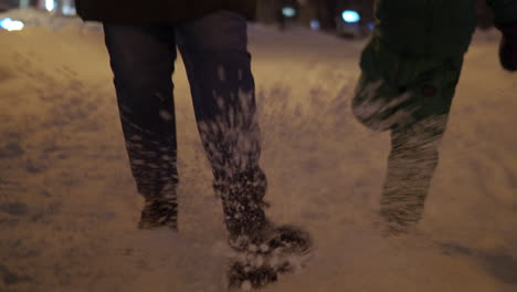Mum-and-daughter-kicking-snow-on-the-sidewalk