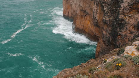 Azure-ocean-waves-crashing-rocks-of-Cape-St-Vincent-in-Portugal