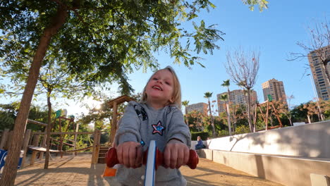 Cheerful-kid-on-the-seesaw-on-playground