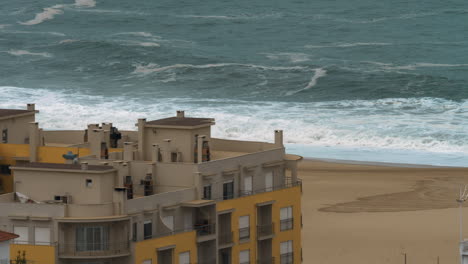 Beachline-hotel-and-ocean-waves-in-Nazare-Portugal