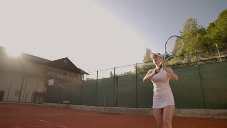 Tennis-game-on-sunny-day-at-tennis-court-young-sportive-woman-playing-professional-tennis.