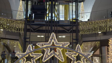Customers-in-shopping-centre-with-Christmas-lights-and-decoration