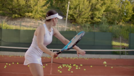 Woman-tennis-player-practicing-hitting-the-ball-with-the-coach-hitting-the-ball-with-a-racket-in-slow-motion.-Professional-tennis-player-training.