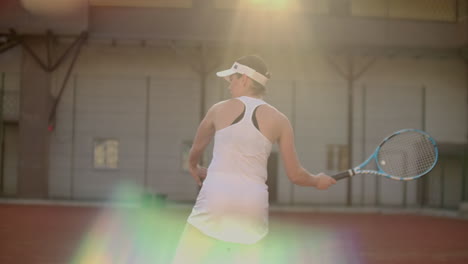 Tennis-game-on-sunny-day-at-tennis-court-young-sportive-woman-playing-professional-tennis.-Tennis-game-on-sunny-day