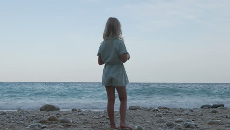 Little-girl-stands-on-the-seashore