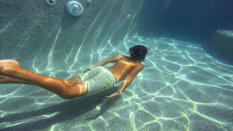 Slow-motion---a-teenager-swims-in-a-pool-underwater