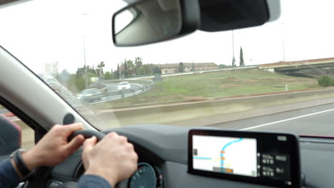 Man-driving-outside-the-city-and-following-GPS-route