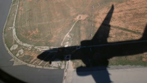 The-shadow-of-airplane-is-approaching-the-ground