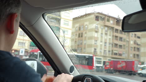 Man-is-very-attentive-when-driving-in-the-city-under-the-rain