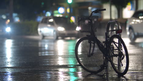 Bicycle-parked-on-the-street-during-rainy-evening