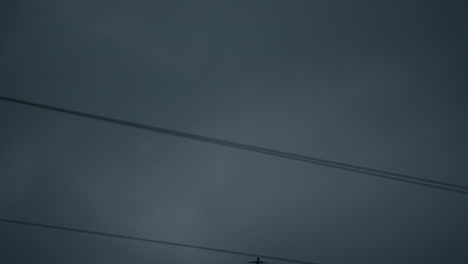 Aircraft-flying-over-power-lines