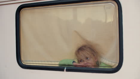 Thoughtful-Blonde-Girl-Inside-Camper-Van