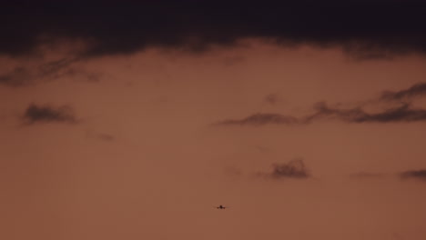Airplane-in-the-sunset-cloudy-sky-in-slow-motion