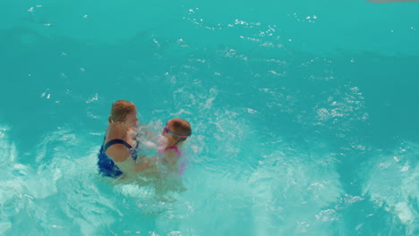 Playful-mother-and-daughter-in-pool