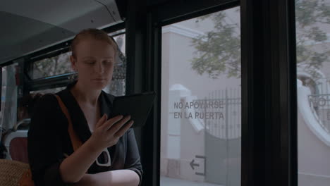 Young-woman-reading-e-reader-in-the-bus