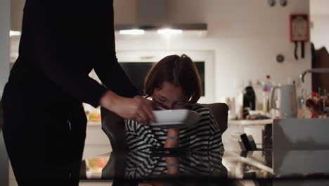 Teen-boy-watching-video-while-eating-spaghetti