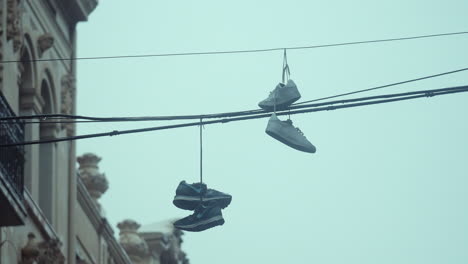 Sneakers-hanging-on-electric-wires-in-rainy-weather