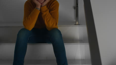 Sad-teenage-boy-crying-on-stairs