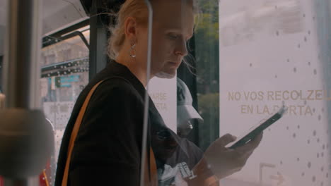 Mujer-Joven-Con-Libro-Electrónico-En-El-Autobús