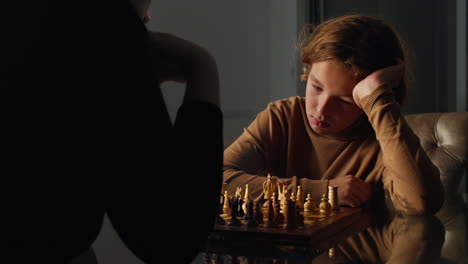 Young-boy-intently-studies-the-chessboard-and-makes-a-move