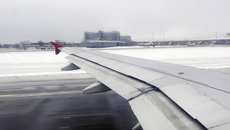 Wing-of-an-airplane-taking-off-in-winter