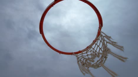Basketball-hoop-with-a-tattered-net