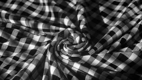 A-Monochromatic-Checkered-Fabric-Spirals-Into-a-Hypnotic-Pattern-Evoking-a-Classic-yet-Contemporary