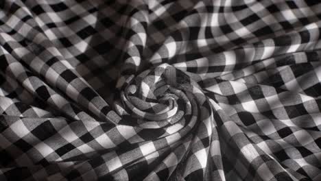 A-Monochromatic-Checkered-Fabric-Spirals-Into-a-Hypnotic-Pattern-Evoking-a-Classic-yet-Contemporary