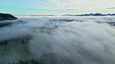 Aerial-view-of-clouds-over-a-village-at-dawn-at-Attersee,-a-Village-in-Austria