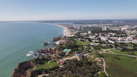 Aerial-Scenic-View-Of-Portimao-Coastline-With-Torralta-Beach-In-Background-On-Sunny-Day