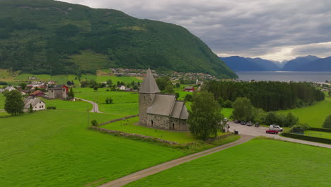 Beautiful-cinematic-aerial-footage,-historic-stone-Hove-parish-church
