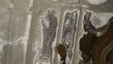 An-intricate-aerial-drone-capture-showcasing-the-formation-of-salt-particles-on-the-terrain-of-Salt-Valley
