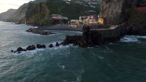 Vibrant-colorful-town-of-Ponta-do-Sol-Madeira,-Portugal-at-sunset,-aerial-establish-reveals-out-to-ocean
