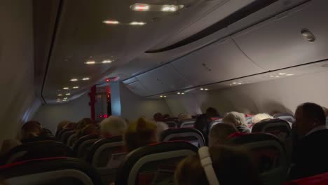 Full-flight-inside-an-airplane,-with-everyone-facing-away-from-the-camera