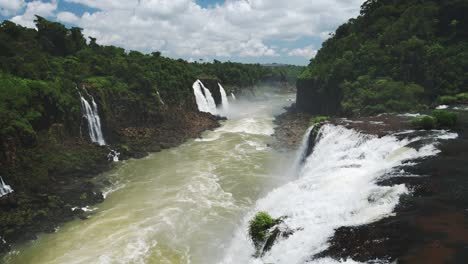Looking-Down-Long-Stretch-of-Beautiful-Waterfall-Valley,-Slow-Motion-Strong-Rivers-in-Sunny-Brazil,-Rough-Currents-from-Falling-Waterfalls-in-Large-Pool-Streams-in-Iguazu-Falls,-South-America