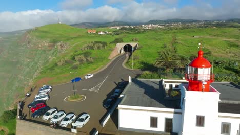 Drone-pullback-reveals-Ponta-do-Pargo-lighthouse-on-scenic-cliff-vista-in-Madeira-Portugal