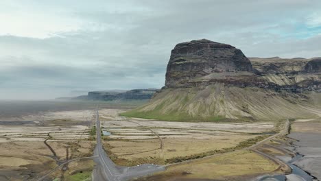 Vista-Aérea-De-La-Carretera-Número-1-Cerca-De-La-Majestuosa-Montaña-Lomagnupur-En-El-Sur-De-Islandia