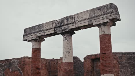 Carved-stone-architrave-atop-ruins-in-Pompeii,-Italy