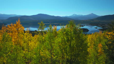 Early-fall-yellow-colors-Aspen-trees-Lake-Dillon-Colorado-aerial-cinematic-drone-morning-view-Frisco-Breckenridge-Silverthorne-Ten-Mile-Range-calm-reflective-water-wide-dolly-jib-upward-movement