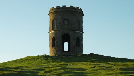 Historic-stone-tower-landmark-on-a-grassy-hill