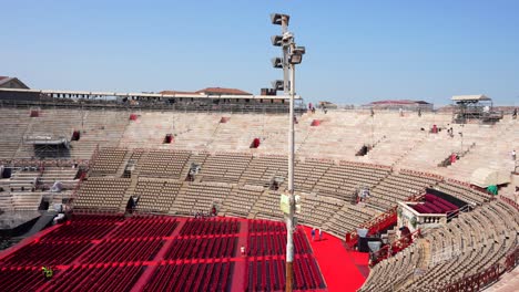 Arena-di-Verona,-ancient-Roman-amphitheater-with-tourists-and-stage-for-opera-concerts,-Italy